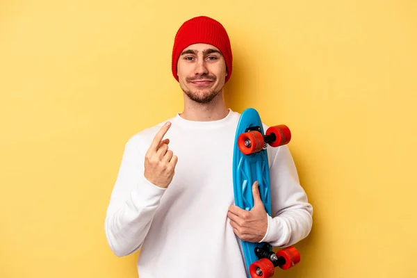 Young Skater Caucasian Man Isolated Yellow Background Pointing Finger You — Fotografia de Stock