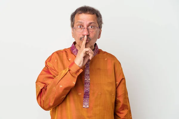 Senior indian man wearing a Indian costume isolated on white background keeping a secret or asking for silence.