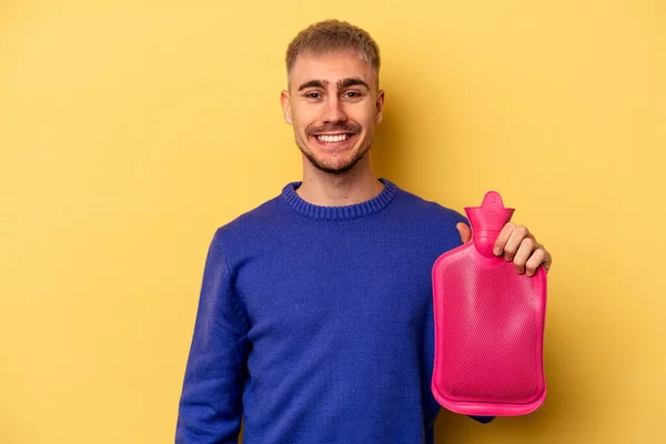 Young Caucasian Man Holding Water Bag Isolated Yellow Background Happy — Foto Stock