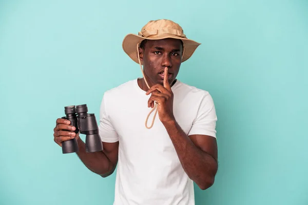 Young African American Man Holding Binoculars Isolated Blue Background Keeping — Stock Photo, Image