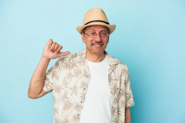 Senior indian man wearing summer clothes isolated on blue background Senior indian woman wearing a african costume isolated on white background showing a dislike gesture, thumbs down. Disagreement concept.