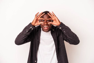 Beyaz arka planda izole edilmiş genç Afro-Amerikan bir başarı fırsatı bulmak için gözlerini açık tutuyor..