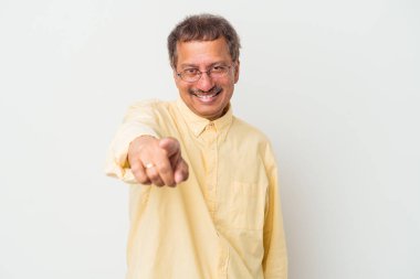 Middle aged indian man isolated on white background cheerful smiles pointing to front.