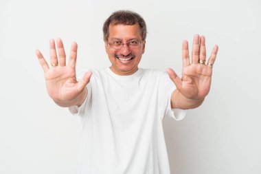 Middle aged indian man isolated on white background showing number ten with hands.