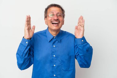 Middle aged indian man isolated on white background laughs out loudly keeping hand on chest.