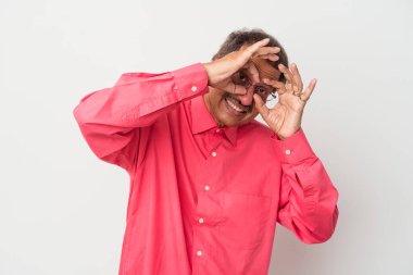 Middle aged indian man isolated on white background showing okay sign over eyes