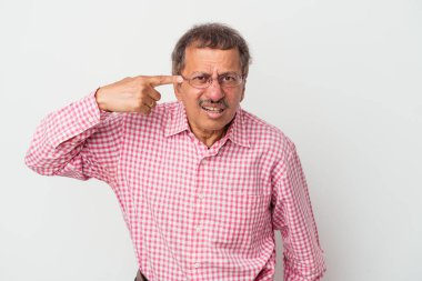 Middle aged indian man isolated on white background showing a disappointment gesture with forefinger.