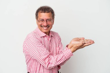 Middle aged indian man isolated on white background holding a copy space on a palm.