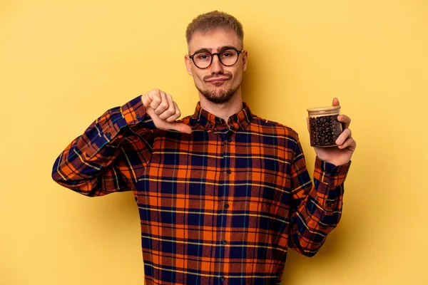 Young Caucasian Man Holding Coffee Jar Isolated Yellow Background Feels — Stockfoto