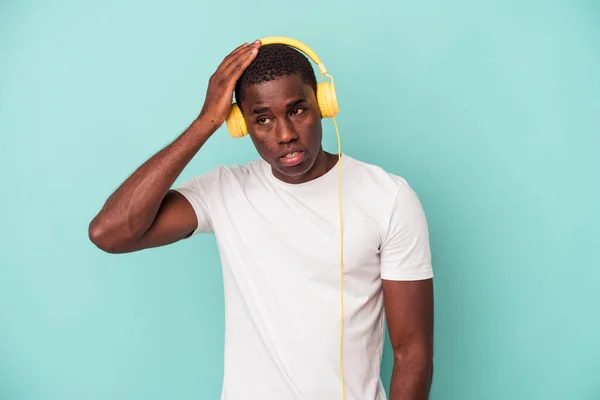 Young African American Man Listening Music Isolated Blue Background Being — ストック写真