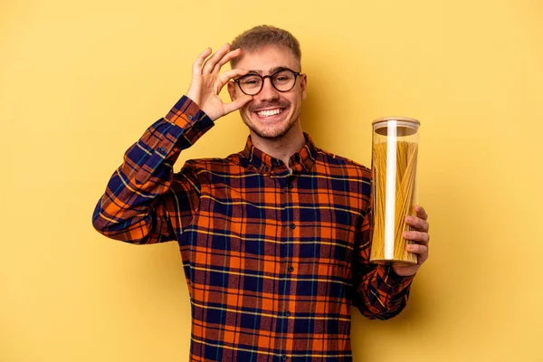 Young Caucasian Man Holding Spaghettis Jar Isolated Yellow Background Excited — Stock fotografie