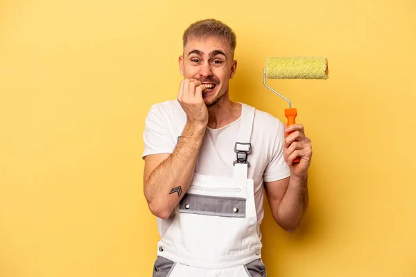 Young Painter Man Isolated Yellow Background Biting Fingernails Nervous Very — Stock Photo, Image