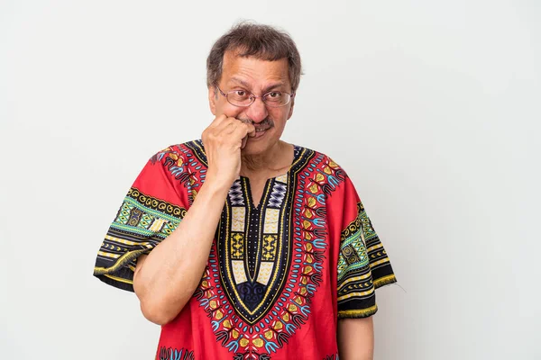 Senior indian man wearing a Indian costume isolated on white background biting fingernails, nervous and very anxious.