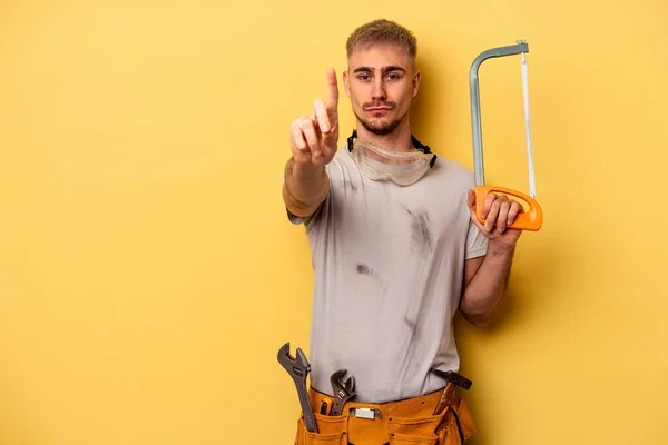 Young Electrician Caucasian Man Isolated Yellow Background Showing Number One — Foto Stock