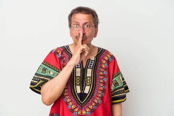 Senior indian man wearing a Indian costume isolated on white background keeping a secret or asking for silence.