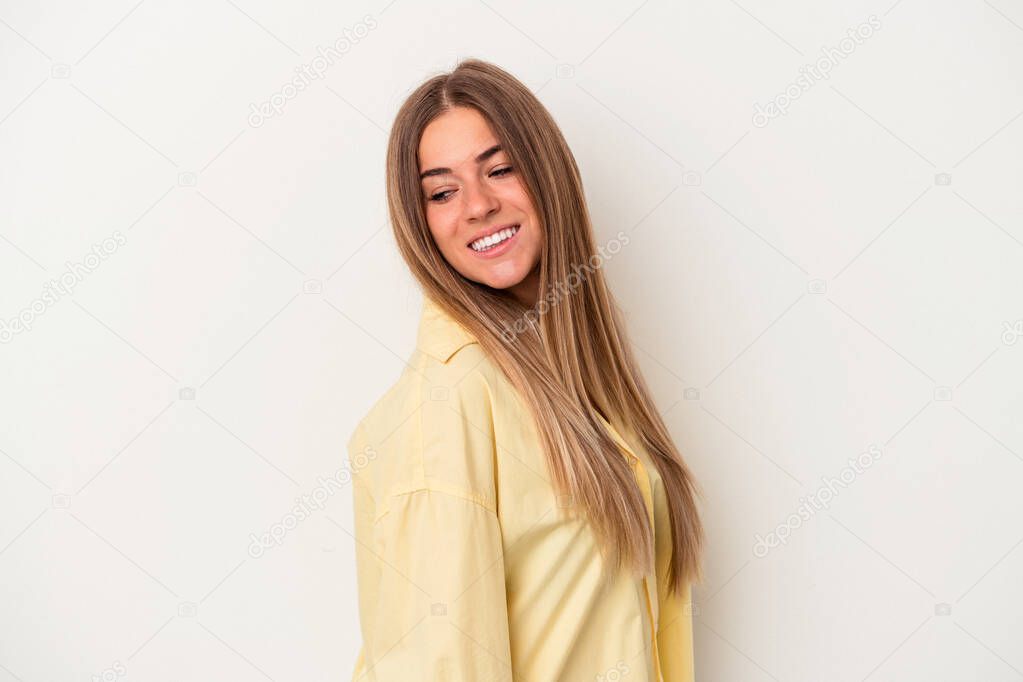 Young Russian woman isolated on white background looks aside smiling, cheerful and pleasant.