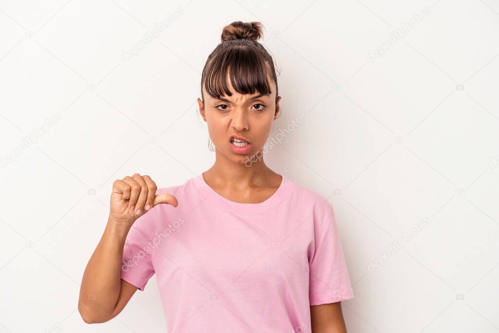 Young mixed race woman isolated on white background  showing thumb down, disappointment concept.