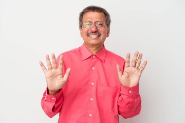Middle aged indian man isolated on white background rejecting someone showing a gesture of disgust.