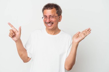 Middle aged indian man isolated on white background holding and showing a product on hand.