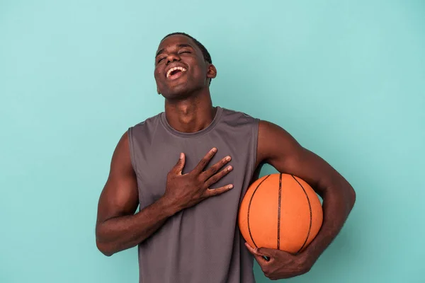 Young African American Man Playing Basketball Isolated Blue Background Laughs — Stock Photo, Image