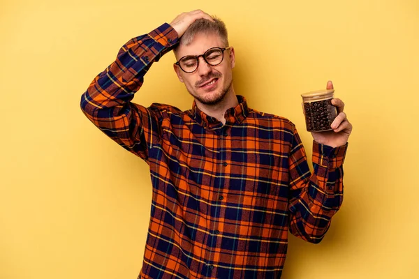 Young Caucasian Man Holding Coffee Jar Isolated Yellow Background Being — Zdjęcie stockowe