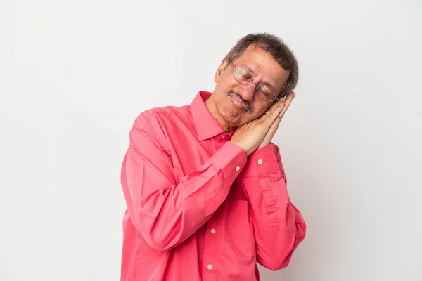 Middle aged indian man isolated on white background yawning showing a tired gesture covering mouth with hand.