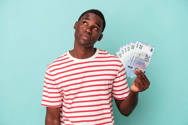 Young African American Man Holding Bank Notes Isolated Blue Background — Stock Photo, Image