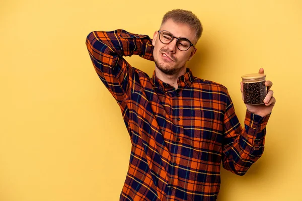 Young Caucasian Man Holding Coffee Jar Isolated Yellow Background Touching — Stockfoto