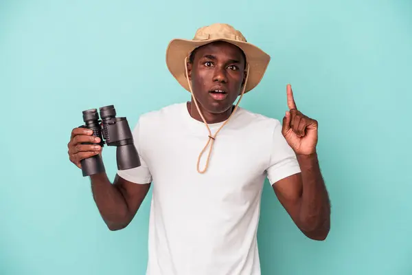Young African American Man Holding Binoculars Isolated Blue Background Having — ストック写真
