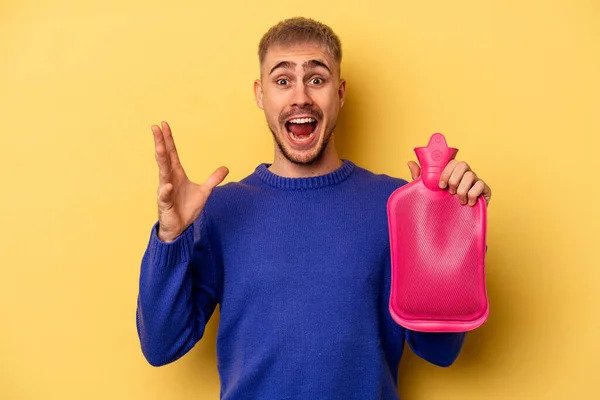 Young Caucasian Man Holding Water Bag Isolated Yellow Background Receiving — Fotografia de Stock