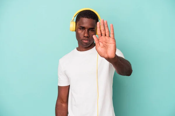 Young African American Man Listening Music Isolated Blue Background Standing — ストック写真