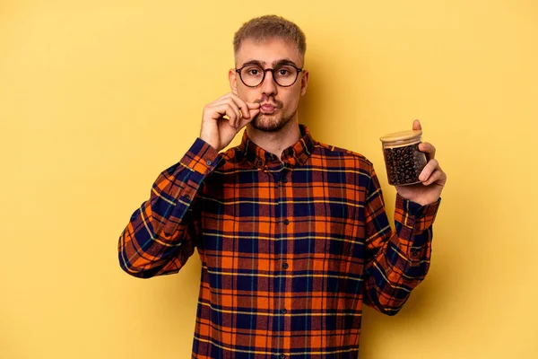 Young Caucasian Man Holding Coffee Jar Isolated Yellow Background Fingers — Zdjęcie stockowe