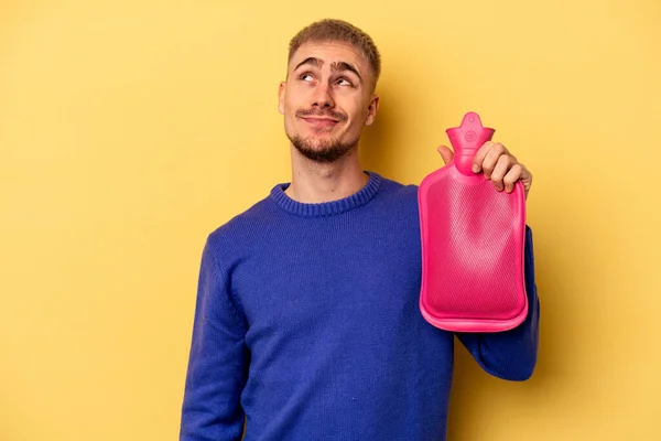 Young Caucasian Man Holding Water Bag Isolated Yellow Background Dreaming — Fotografia de Stock