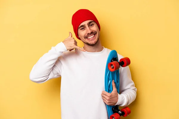 Young Skater Caucasian Man Isolated Yellow Background Showing Mobile Phone — Fotografia de Stock