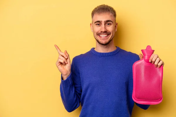 Young Caucasian Man Holding Water Bag Isolated Yellow Background Smiling — Fotografia de Stock