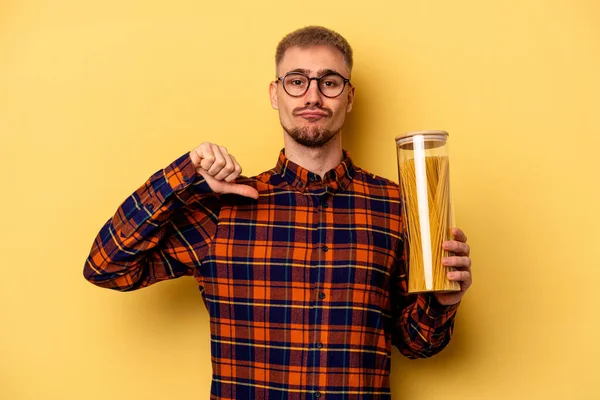 Young Caucasian Man Holding Spaghettis Jar Isolated Yellow Background Feels — Stock fotografie