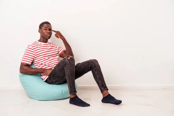 Young African American Man Sitting Puff Isolated White Background Showing — Stock Photo, Image