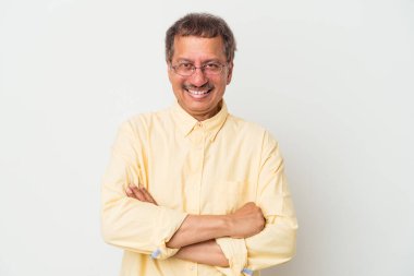 Middle aged indian man isolated on white background who feels confident, crossing arms with determination.
