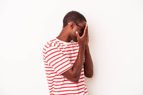 Young African American man isolated on white background afraid covering eyes with hands.