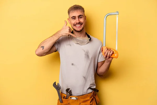 Young Electrician Caucasian Man Isolated Yellow Background Showing Mobile Phone — 스톡 사진