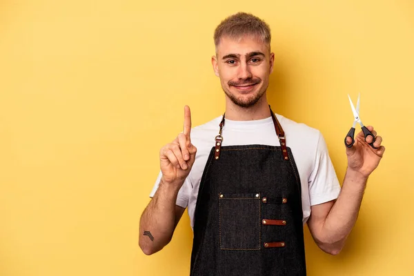 Young Caucasian Hairdresser Man Holding Scissors Isolated Yellow Background Showing — Stock fotografie