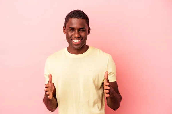 Young African American Man Isolated Pink Background Holding Something Both — Stock Photo, Image