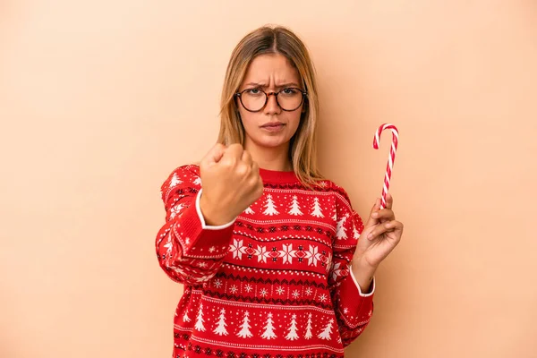 Young Caucasian Woman Holding Christmas Stick Isolated Beige Background Showing — Stok fotoğraf