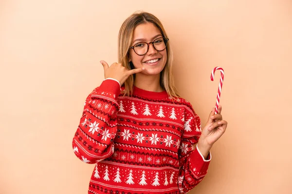 Young Caucasian Woman Holding Christmas Stick Isolated Beige Background Showing — Photo