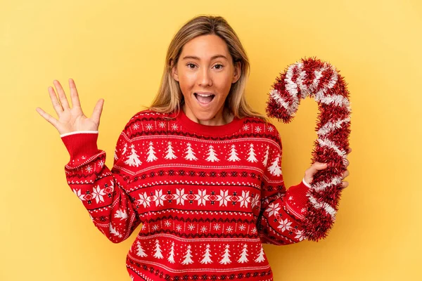 Young Caucasian Woman Holding Big Christmas Stick Isolated Yellow Background — Stock Photo, Image