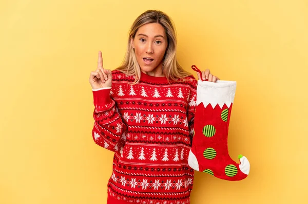 Young Caucasian Woman Holding Elf Sock Isolated Yellow Background Having — Stock Photo, Image