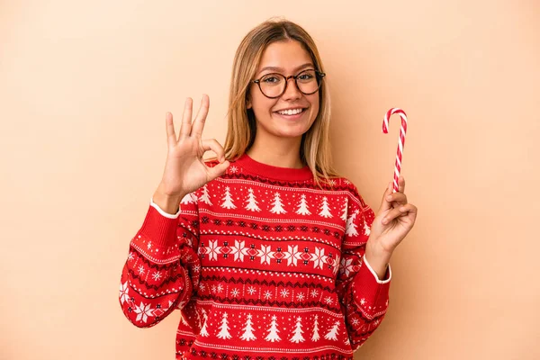 Young Caucasian Woman Holding Christmas Stick Isolated Beige Background Cheerful — Stok fotoğraf