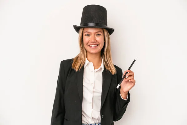 Young caucasian wizard woman holding wand isolated on white background happy, smiling and cheerful.