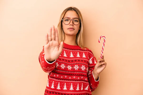 Young Caucasian Woman Holding Christmas Stick Isolated Beige Background Standing — Stok fotoğraf