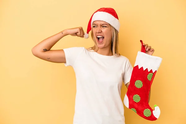 Young Caucasian Woman Holding Elf Sock Isolated Yellow Background Raising — Stock Photo, Image